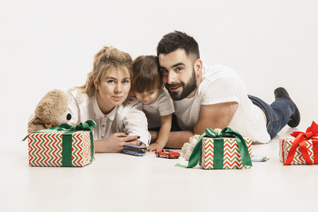The happy family with kid posing together on white studio backgroundの写真素材