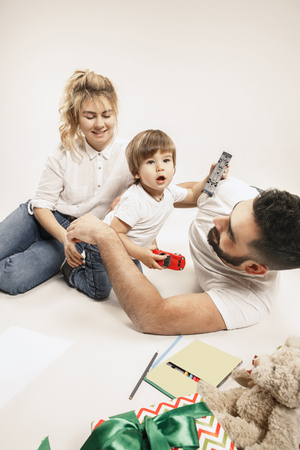 The happy family with kid posing together on white studio backgroundの写真素材