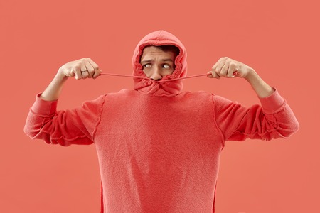 Im afraid. Fright. Portrait of the scared man. Business man standing isolated on trendy coral studio background. male half-length portrait. Human emotions, facial expression conceptの写真素材
