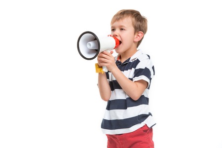 Little cute kid baby boy holding in hand and speaking in electronic gray megaphone isolated on white background. Kids childhood lifestyle concept. Copy spaceの写真素材