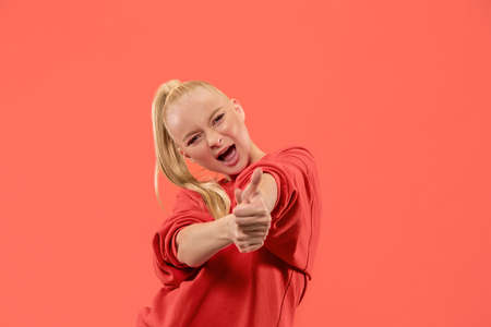 I am ok. Happy business woman, sign ok, smiling, isolated on trendy coral studio background. Beautiful female half-length portrait. Emotional woman. Human emotions, facial expression conceptの写真素材