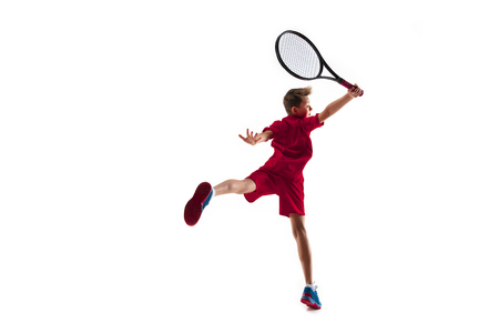 Young teen boy tennis player in motion or movement isolated on white studioの写真素材