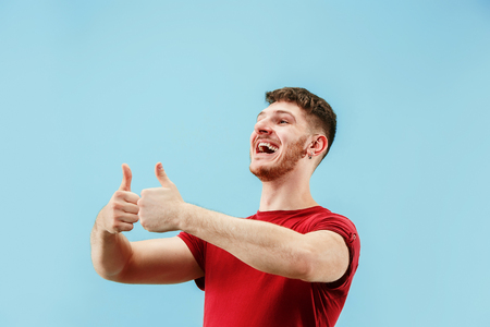 I am ok. Happy businessman, sign ok, smiling, isolated on trendy blue studio background. Beautiful male half-length portrait. Emotional man. Human emotions, facial expression conceptの写真素材