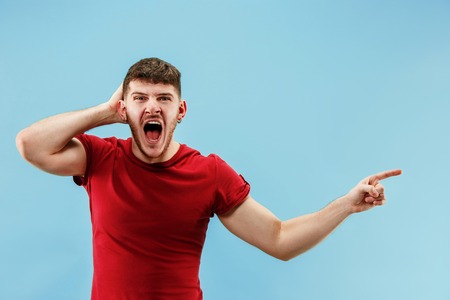 Do not miss. Young casual man shouting. Shout. Crying emotional man screaming on blue studio...