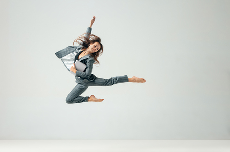 Happy business woman dancing and smiling in motion isolated over white studio background. Human emotions concept. The businesswoman, office, success, professional, , happiness, expression conceptsの写真素材