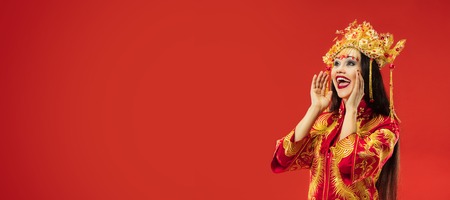 Chinese traditional graceful woman shouting at studio over redの写真素材