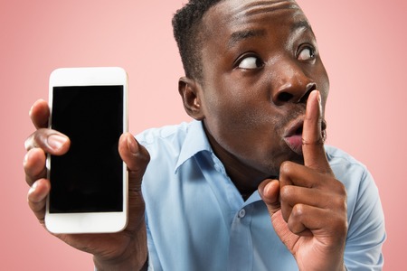 Indoor portrait of attractive young black african man isolated on pinkの写真素材