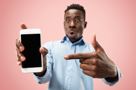 Indoor portrait of attractive young black african man isolated on pinkの写真素材