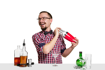 Expert male barman is making cocktail at studio isolated on white background. International barman...