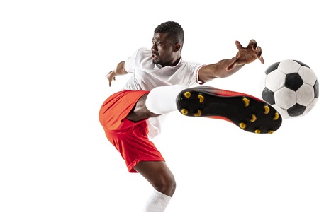 Professional african american football soccer player in motion isolated on white studio background. Fit jumping man in action, jump, movement at game.の写真素材