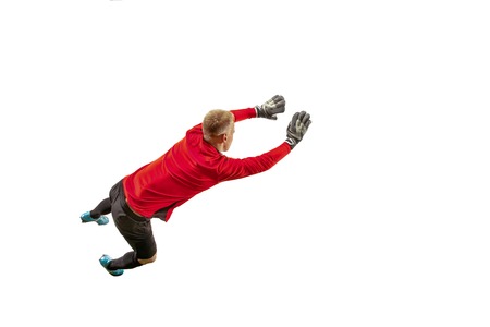Male soccer player goalkeeper catching ball in jump. Silhouette of fit man with ball isolated on...