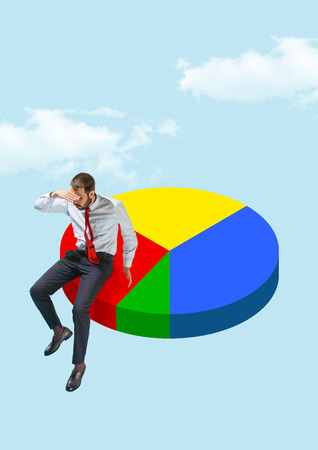 Businessman sitting on pie chart of sales. business processes, finance, graph, growth, diagram, sales, statistics conceptの写真素材