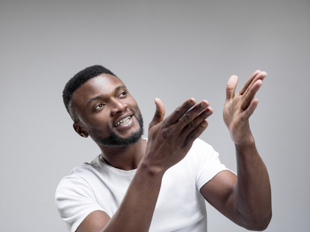 African american man excited about watching tv. Human emotions conceptの写真素材