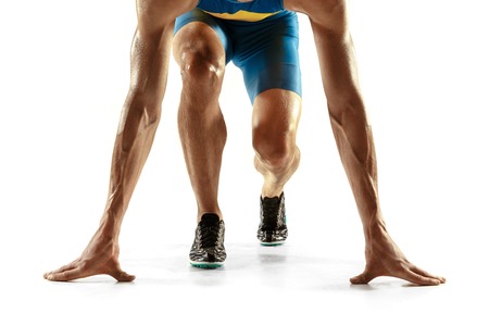 Young caucasian man preparing to run isolated on white studio background. One male runner or jogger. Silhouette of jogging athlete with shadows.の写真素材