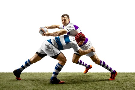 The silhouette of two caucasian rugby male players isolated on white background. Studio shot of fit men in motion or movement with ball. Jump and action concept. An incredible strain of all forces.の写真素材
