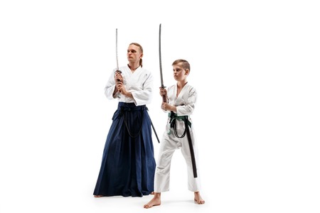 Man and teen boy fighting at Aikido training in martial arts school. Healthy lifestyle and sports...