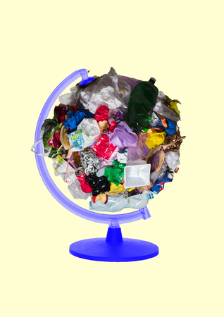Environmental problems - we live in heart of dirty planet. Ecological catastophy all around the world. Globe full of garbage against light yellow background. Modern design. Contemporary art collage.の写真素材