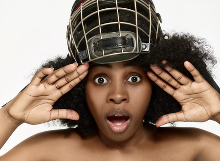 Female hockey player close up helmet and mask over white studio background. African american modelの写真素材