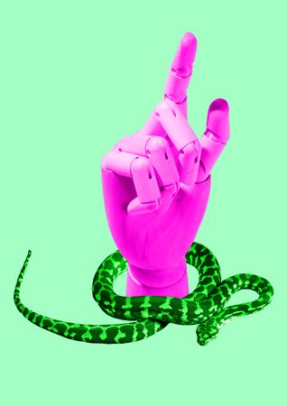 In touch with wild nature. Hi-tech robots pink hand surrounded by bright green snake against mint background. Eco-friendly and environmental concept. Modern design. Contemporary art collage.の写真素材