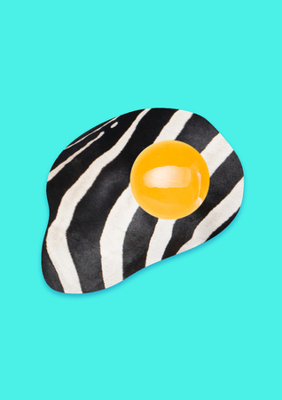 Alternative breakfest. Lets have a snack with zebra. Fried egg or omelette with yellow, black, white colors. Another view of the healthy lunch. Modern design. Contemporary art collage. Food concept.の写真素材