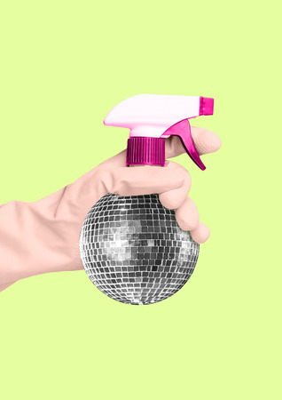 An alternative cleaning - disco spraing bottle. Hand in a housewifely white glove holding spray as a silver discoball against banana colored background. Modern design. Contemporary art collage.の写真素材