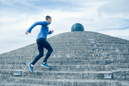 Man running on city background at morning. Healthy lifestyle concept.の写真素材