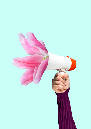 A tender reminder. Social talks may grow into useful things. Males hand holding bullhorn with blossoming light pink flower. Negative space to insert your text. Modern design. Contemporary art collage.の写真素材