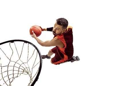 Full length portrait of a basketball player with ball isolated on white background. Advertising...