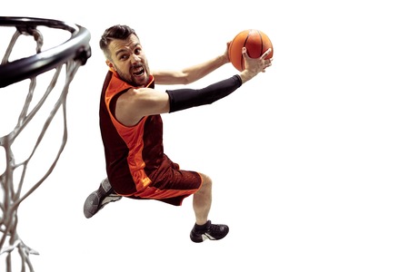 Full length portrait of a basketball player with ball isolated on white background. Advertising...