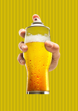 Street art. Male hand holding a glass of cold beer as a spray cannister against yellow-braun background. Modern design. Contemporary art collage. Concept of arts, drawing, drinks or weekend chilling.の写真素材
