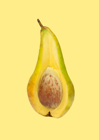 A hidden sense or thoughts or deepest creative idea. Pear outside and avocado inside against yellow...
