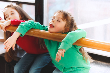 The kids sitting at dance school. Ballet, hiphop, street, funky and modern dancers concept. Studio background. Teens in hip hop style. Sport, fitness and lifestyle concept.の写真素材