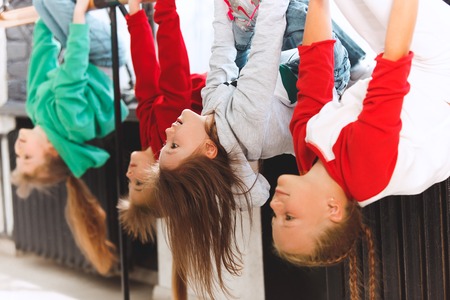 The kids sitting at dance school. Ballet, hiphop, street, funky and modern dancers concept. Studio background. Teens in hip hop style. Sport, fitness and lifestyle concept.の写真素材