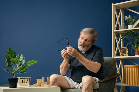How to know is it friendly or danger. Old bearded man with alzheimer desease has problems with his...