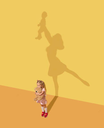 Show you the whole world. Childhood and dream concept. Conceptual image with child and shadow on the...