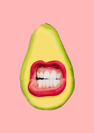 The vegan talks to the world. A half of avocado with female mouth with red lips and white teeth on trendy coral background. Negative space to insert your text. Modern design. Contemporary art collage.の写真素材