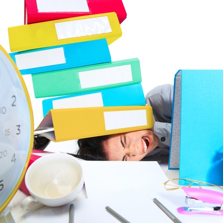 Its enought. Young woman getting a lot of work and deadline, being under the pressure of the deals. Pressed by folders with papers. Concept of office workers troubles, business, problems and stress.の写真素材