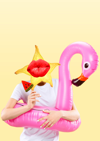 Female body in swim ring headed by a carambola with kissing lips against yellow background. Negative space to insert your text. Modern design. Contemporary art collage. Vacation, summer, resort.の写真素材