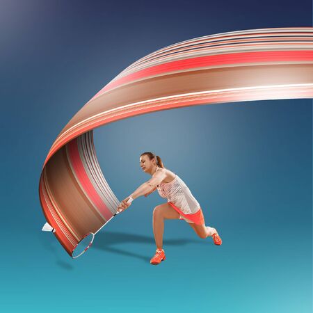 Full length portrait of young woman playing badminton isolated on blue background. Healthy lifestyle. Fitness, sport, action, advertising concept. Female model in motion or movement. Abstract design.の写真素材
