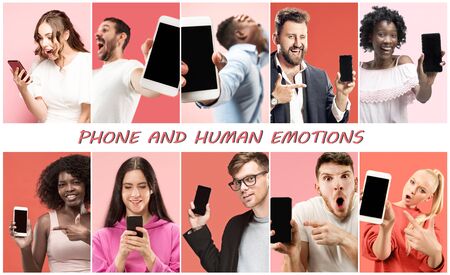Portrait of people showing mobile phones isolated over coralの写真素材