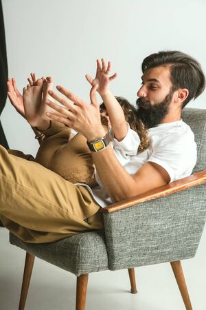 Father playing with young son in their sitting room at home. Young dad having fun with his children...