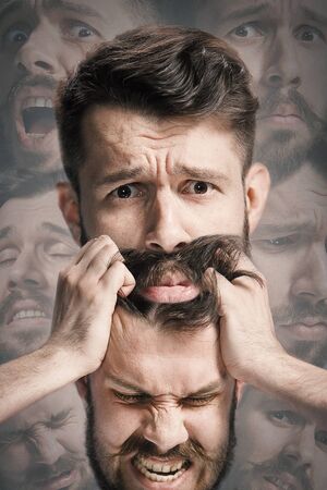Close up shot of sad and angry emotion on face of discouraged man. Young caucasian male model...