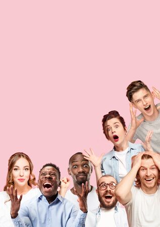 Collage of close up portraits of 7 young people on coral pink background. The human emotions, facial expression concept. Celebrating, wondering, feeling like a winners, astonished and shocked.の写真素材