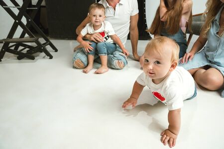 Young family spending time together and smiling. Parents with young daughter and little sons playing and laughting. Family lifestyle. Mothers, fathers day, togetherness, parenthood, kids rights concept.の写真素材