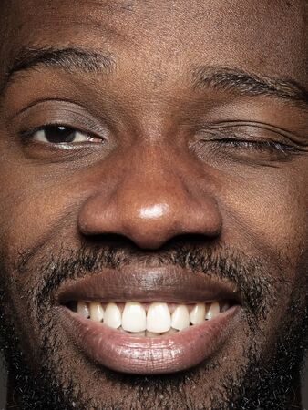 Close up portrait of young and emotional african-american man. Highly detail photoshot of male model...