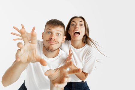 Beautiful young couples portrait isolated on white studio background. Facial expression, human...