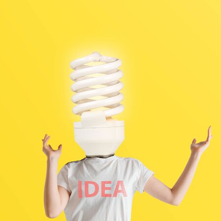 Have a great idea. Human body headed by the lightbulb on yellow background. Negative space to insert your text. Modern design. Contemporary art. Creative conceptual and colorful collage.の写真素材