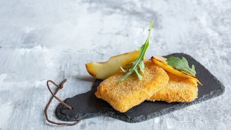 Close up photo of meat snacks on wooden kitchen plate and white stone background. Delicious food for alcohol drinks, beer. Concept of drinks, fun, food, celebrating, meeting, oktoberfest.の写真素材