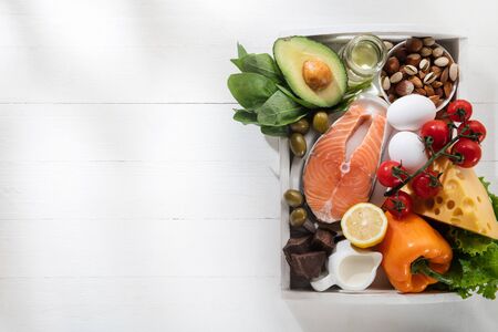 Ketogenic low carbs diet - food selection on white background. Balanced healthy organic ingredients of high content of fats for the heart and blood vessels. Meat, fish and vegetables. Copyspace.の写真素材