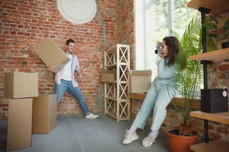 Build the future together. Young couple moved to a new house or apartment. Look happy and confident....